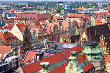 Fototapeta na wymiar Multicolored historical houses on the Market square at Old Town in Wroclaw, Poland. Top view from the Bridge of Penitents of Cathedral of St. Mary Magdalene