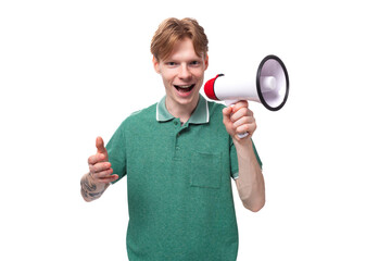 young european man with red hair enthusiastically reports the news through a megaphone