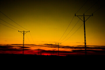 Fototapeta na wymiar power poles against the background of the evening sky