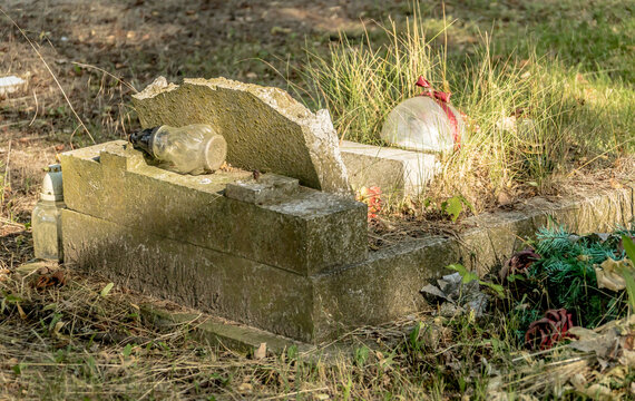 old abandoned and devastated tombstone with a broken ledger