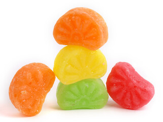 mixed fruit sugar syrup candies on white background, orange candies 