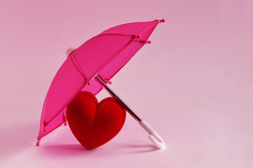 Heart under pink umbrella - Love and protection concept