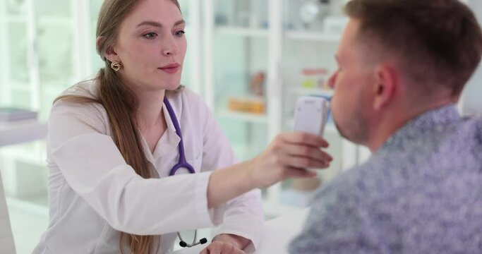 Doctor gives a patient abreathalyzer to measure blood alcohol levels. Driver alcohol testing