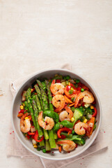Stir fried shrimps with asparagus, vegetables. Cooked healthy food.