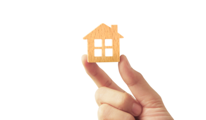 holding house representing home ownership and the Real Estate business