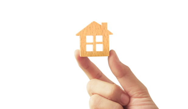 holding house representing home ownership and the Real Estate business