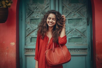Fototapeta premium A Fictional Character Created By Generative AI.Elegant woman with curly hair wearing a red dress and a brown purse