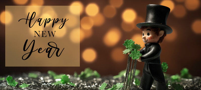 New year greeting card, New Year's Eve celebration holiday  - Happy chimney sweep with top hat and four leaves clover, glitter palettes on table and bokeh lights in background