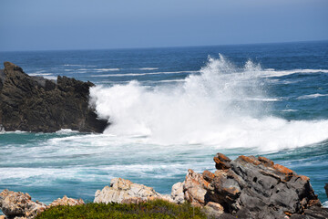 Waves crash over rocks
