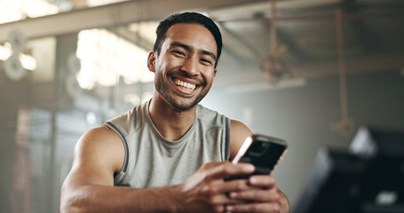 Happy asian man, phone and fitness in social media, communication or networking at gym. Portrait of active male person smile for online texting or chatting on mobile smartphone at indoor health club - obrazy, fototapety, plakaty