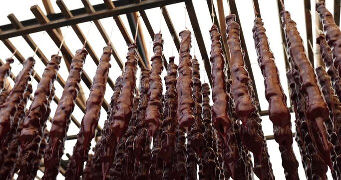 Traditional Georgian dessert drying in sun at Churchkhela factory in Georgia. Churchkhela traditional Georgian homemade sweet with nuts and grape juice