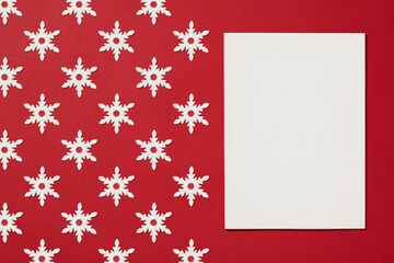 Magazine cover mockup with white snowflake Christmas ornament flat lay on red background