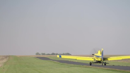 Crop Duster Plane Taking Off from Rural Runway to Seed Farm Field