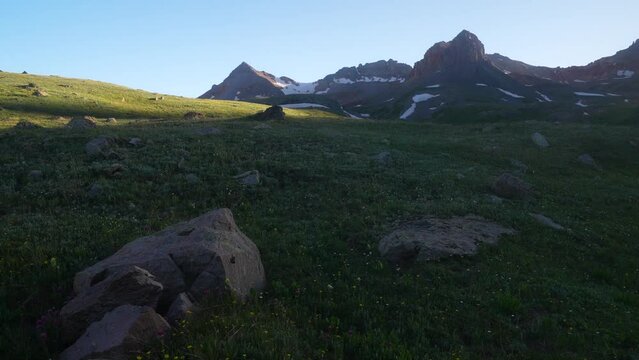 Cinematic slider right wildflower golden hour  Ice Lake Basin Silverton Telluride Ouray Trailhead top of summer snow melted peak sunset in Rocky Mountains valley afternoon dusk stunning landscape