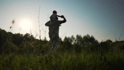 father's day. Happy family in park.Family love.Father play with his son in nature in summer in park on father's family day.Father in park with his son around his neck at sunset.Happy family silhouette