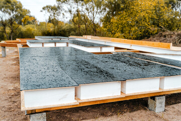 Building construction of wooden frame house made of SIP structural insulated panels. OSB oriented...