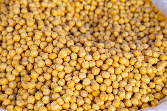 the yellow colored peas on top of a bowl and displayed them for sale in the shop