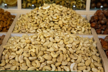 Dry cashews are kept on top of a box for sale outside the shop