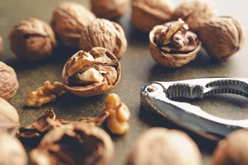 Rolgordijnen Walnut and nutcracker on vintage background © banusevim