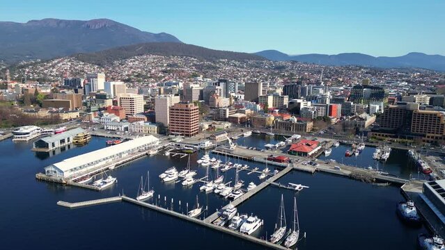 Hobart, Tasmania: Aerial drone footage of the Hobart downtown district and the harbor in Tasmania largest city in Australia. Shot with a rotation motion with Mt Wellington in the background