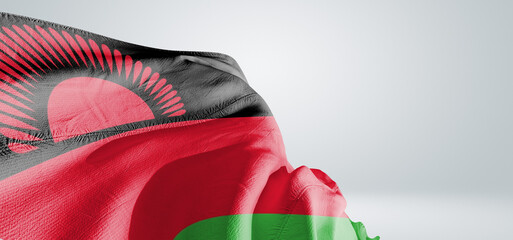 Malawi national flag cloth fabric waving on beautiful sky Background.