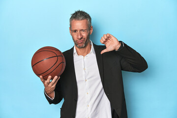 Middle-aged basketball coach on blue backdrop Middle-aged basketball coach on blue backdropfeels...