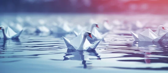 Fototapeten Depicting various origami swans floating on water a bold bird illustrates the concepts of transformation and bravery in business © AkuAku