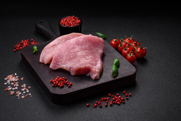 Raw turkey meat in the form of slices with salt, spices and herbs