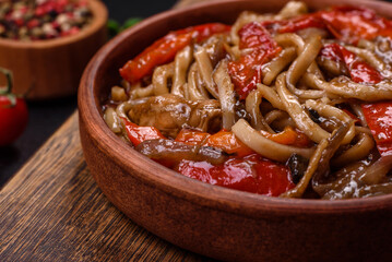 Delicious asian udon dish with vegetables, mushrooms, salt and spices
