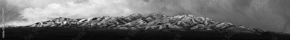 Wall mural Stunning aerial view of a mountain, shrouded in a cloak of clouds