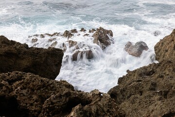 Beautiful blue wavy ocean in a rocky beach