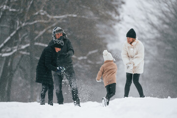 Fototapeta na wymiar Active people. Happy family is outdoors, enjoying snow time at winter together