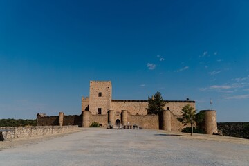 Beautiful exterior view of the Pedraza castle against a clear blue sky