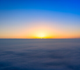 Naklejka na ściany i meble New Day Begins: Sunrise Over the Cloudy Horizon