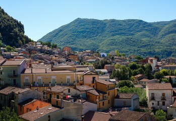 High angle of the beautiful buildings and forested hills of Lauria on a bright summer day in Italy