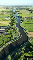 Aerial shot of the Eem River meandering through the picturesque countryside of Eemnes, Netherlands