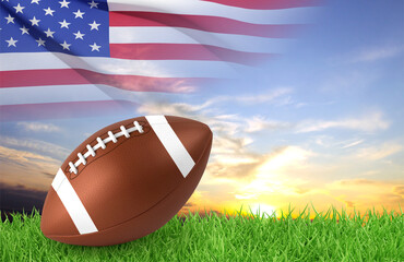 American football ball on a grass against the sunset with USA flag. 3d-rendering