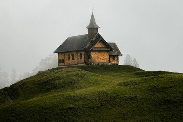 Fototapeta na wymiar Exterior view of an old church on top of a hill in the Alpine region of Switzerland