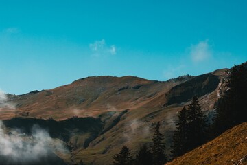 Scenic view of a mountainous landscape in sunny weather in blue sky background