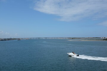 Aerial view of a boat sailing in a sea on a sunny day
