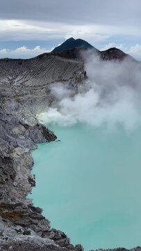 Acid lake with sulfur steam near Mount Ijen, Java, Indonesia, vertical footage