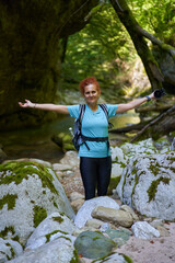 Woman hiker with backpack in a gorge