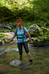 Woman hiker with backpack in a gorge