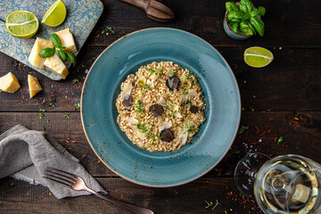 Risotto with champagne, truffle and parmesan. Menu for a restaurant. Beautiful composition on wooden boards.