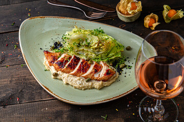 Grilled duck fillet baked with cabbage. Menu for a restaurant. Beautiful composition on wooden boards.
