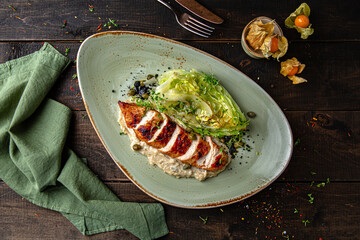 Grilled duck fillet baked with cabbage. Menu for a restaurant. Beautiful composition on wooden boards.