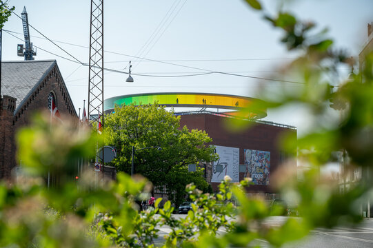 ARoS art museum in Aarhus, view from the distance, nature and tree leaves in front