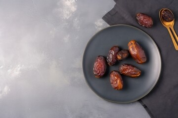 Dates on top of plates on top of clean concrete table