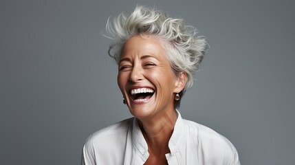 Elderly woman with gray hair is laughing and smiling, mature old lady with healthy face ans skin...