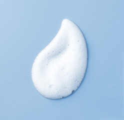 White skincare cleansing foam on light blue background